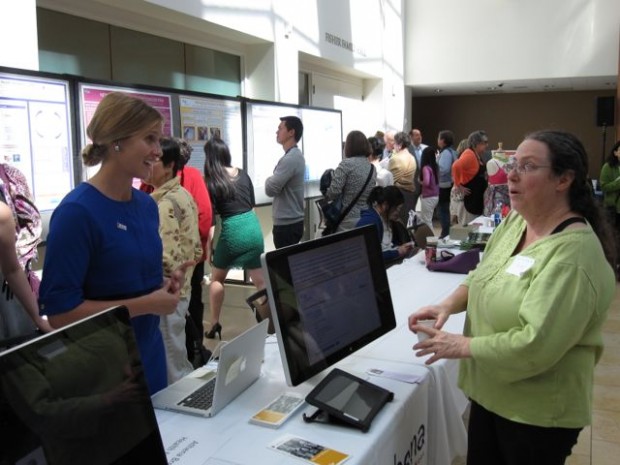 At Taste for the Cure: A Taste of Science, a participant talks with a representative from the Athena Breast Health Network, a program to provide personalized breast cancer prevention for 150,000 women at all five University of California medical centers.