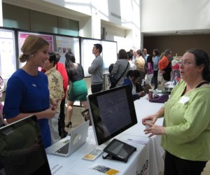 At Taste for the Cure: A Taste of Science, a participant talks with a representative from the Athena Breast Health Network, a program to provide personalized breast cancer prevention for 150,000 women at all five University of California medical centers.