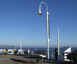 A new streetlight, powered by solar panels bolted to its spine, sits at the end of the Santa Cruz wharf. 